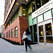 Person walking in front of the Osher Building